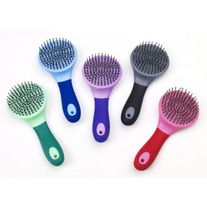 a colorful assortment of mane and tail brushes for horses on a white background