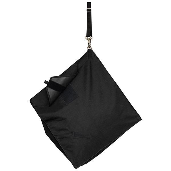 the back of a black slow feed hay bag for horses hanging at a 45 degree angle on a white background