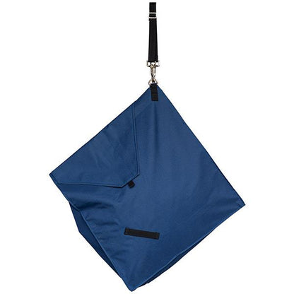 the back of a navy slow feed hay bag for horses hanging at a 45 degree angle on a white background