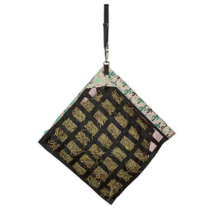 a cactus print slow feed hay bag for horses hanging at a 45 degree angle on a white background