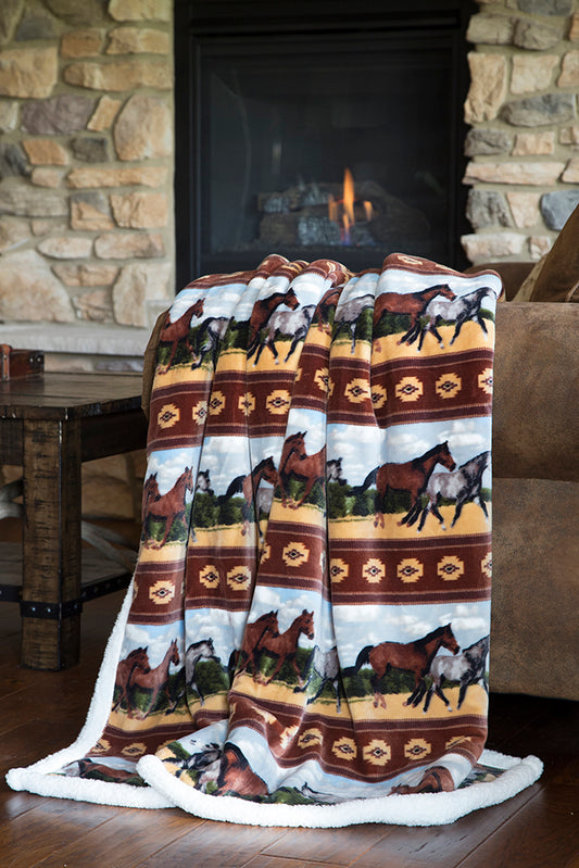 a horse patterned sherpa throw blanket on a sofa in a living room setting