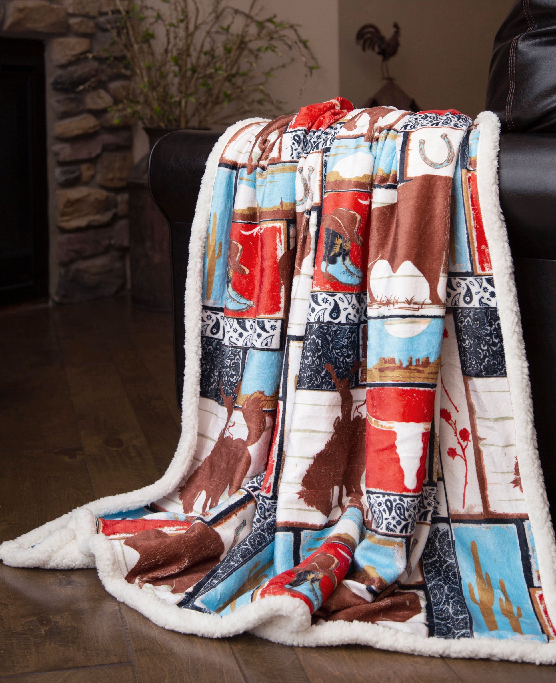 a rodeo themed sherpa blanket draped over a sofa in a living room setting