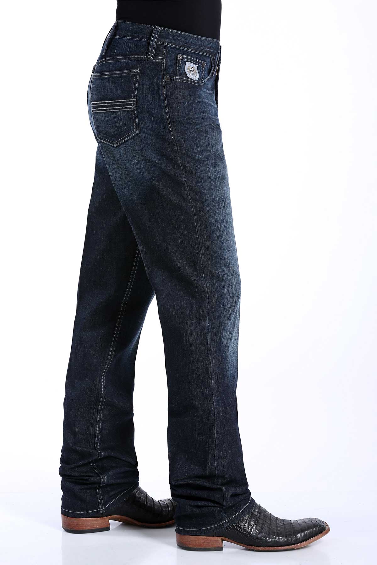 A pair of men's dark rinse denim jeans by Cinch with a slim seat and thigh, straight leg with a boot cut opening, mid-rise waist, and a small logo on the pocket.
