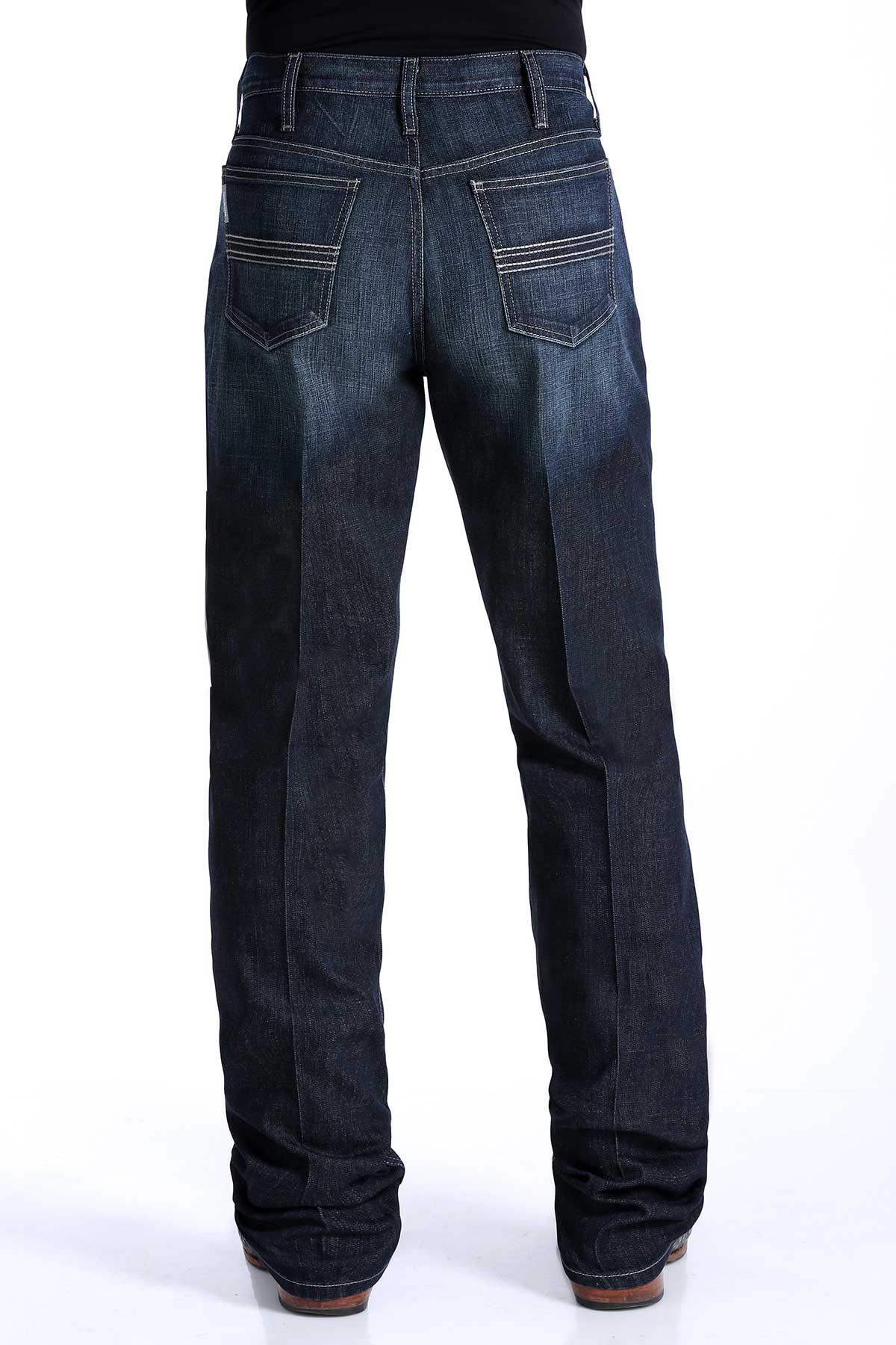 the back of a pair of men's dark rinse denim jeans by Cinch with a slim seat and thigh, straight leg with a boot cut opening, mid-rise waist.