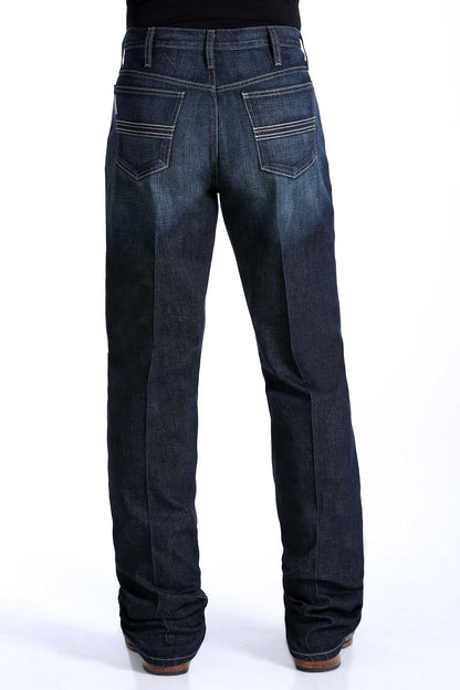 the back of a pair of men's dark rinse denim jeans by Cinch with a slim seat and thigh, straight leg with a boot cut opening, mid-rise waist.