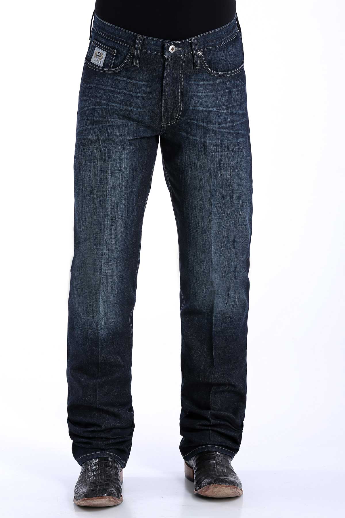 A pair of men's dark rinse denim jeans by Cinch with a slim seat and thigh, straight leg with a boot cut opening, mid-rise waist, and a small logo on the pocket.