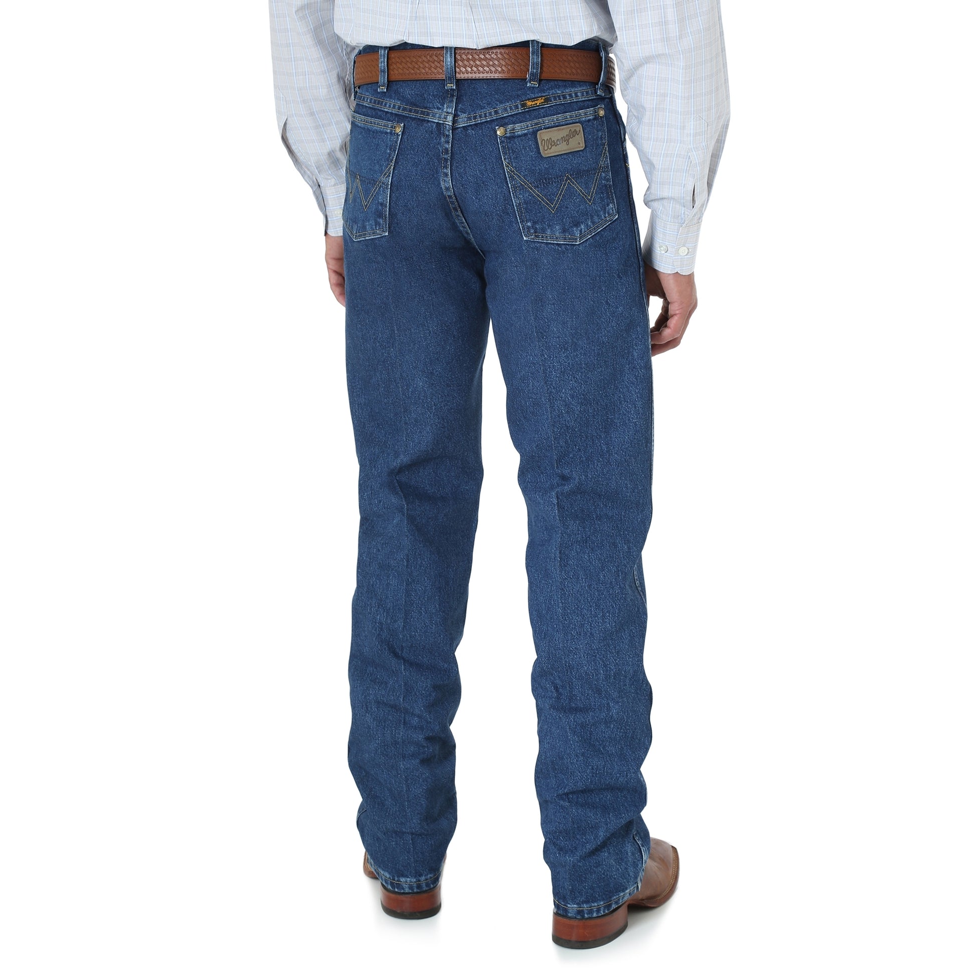 A rear view of a man wearing Wrangler George Strait Original Fit Men's Jeans in a dark stone color, sitting at a table.
